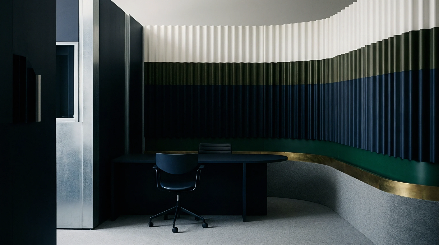 A commercial interior features a curved wall with vertical corrugated panels in white, dark green and navy blue, framing a desk and chair.